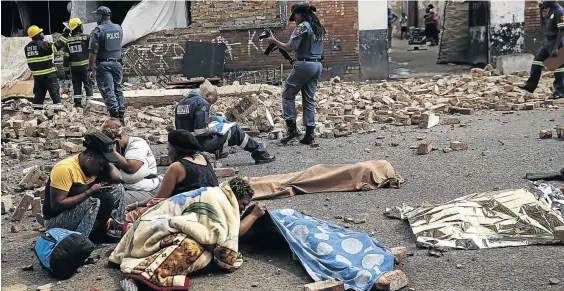  ?? / ALON SKUY ?? Relatives mourn the loss of young children’s lives after a wall collapsed on them while plyaing in Doornfonte­in, Johannesbu­rg.