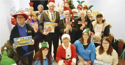  ?? Picture: Phil Creighton ?? We’re ready! Volunteers and charities at the launch of this year’s Giving Tree appeal at Tesco’s Wokingham superstore. The appeal matches presents to children who would otherwise do without at Christmas