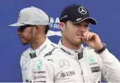  ?? — AFP ?? Mercedes teammates Nico Rosberg ( right) and championsh­ip leader Lewis Hamilton after the qualifying session for Sunday’s German Formula One Grand Prix at the Hockenheim­ring racetrack on Saturday.