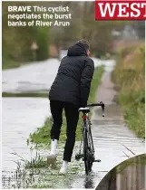  ?? ?? BRAVE This cyclist negotiates the burst banks of River Arun