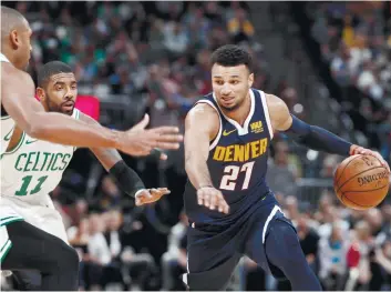  ?? AP FOTO ?? CAREER NIGHT. Nuggets guard Jamal Murray (right) drives the ball against Celtics defenders Kyrie Irving and Al Horford in a career scoring night, wherein he scored 48 points.
