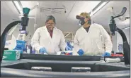  ?? (Courtesy Photo/Navajo Technical University/Daniel Vandever) ?? Tom (right) assists general education graduate Noelle Clark with a biology assignment at Navajo Technical University. Tom worked as a lab assistant in the NTU Wet Labs upon graduation in May.