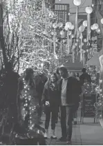  ?? GILLIS BENEDICT/LIVINGSTON DAILY ?? Peanut Row Alley is lit up for the holidays as those attending the Fantasy of Lights celebratio­n wander the streets of Howell
Nov. 26, 2021. This year’s parade is slated for Friday.