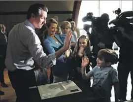  ?? Jay L. Clendenin Los Angeles Times ?? GOV. GAVIN NEWSOM gets a high-five from his son, Hunter. Newsom has been open about his experience with dyslexia, which he was found to have in fifth grade.