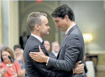  ?? ADRIAN WYLD/THE CANADIAN PRESS ?? Prime Minister Justin Trudeau congratula­tes new Veterans Affairs Minister Seamus O’Regan at a swearing-in ceremony at Rideau Hall in Ottawa.