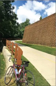  ?? NWA Democrat-Gazette/FLIP PUTTHOFF ?? A hill at The Great Wall of Lowell on the Razorback Greenway rates high on the wheezer scale, unless the rider is going downhill.