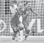  ?? Darryl Dyck / Associated Press ?? Josee Belanger, left, celebrates her goal that lifted Canada over Switzerlan­d and into the quarterfin­als. Christine Sinclair, right, assisted on the score.