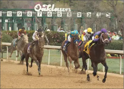  ?? The Sentinel-Record/Richard Rasmussen ?? PACK LEADER: Jockey Luis Saez leads the pack in deep stretch aboard Magnum Moon(4), en route to winning the Rebel Stakes at Oaklawn Park Saturday.