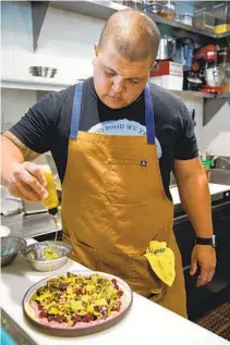  ?? ?? Chef Brad Wise prepares a beet and feta salad, which features a cumin vinaigrett­e that’s a popular dressing at Trust in Hillcrest.