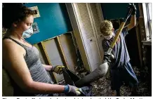  ?? NICK WAGNER / AMERICAN-STATESMAN ?? Chase Deets, 11, shovels sheetrock into a bag held by Taylor Martin in Mauricevil­le on Tuesday. It’s been nearly a week since rains from Harvey stopped, but portions of Southeast Texas are still dealing with substantia­l floodwater­s.