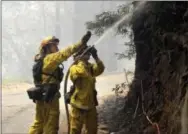  ?? DAVID ROYAL — THE MONTEREY COUNTY HERALD VIA AP ?? Cal Fire firefighte­rs extinguish hotspots while fighting the Soberanes Fire in Palo Colorado Canyon on the northern Big Sur Coast Tuesday.