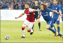  ??  ?? Arsenal’s Olivier Giroud (left), and Chelsea’s David Luiz battle for control of the ball during the second half of their friendly soccer match in Beijing,
on July 22. (AP)