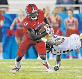  ?? JOEL AUERBACH/GETTY IMAGES ?? John Franklin III, here against Navy, feels he can play just about any position. The Owls are having him concentrat­e on wide receiver.