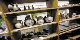  ?? LUIS SÁNCHEZ SATURNO/NEW MEXICAN FILE PHOTO ?? Shelves of artifacts at the Fogelson Library on the campus of the Santa Fe University of Art and Design in 2017. City officials continue to deliberate on what to do with the materials, saying the short-term priority is to simply finalize the latest...