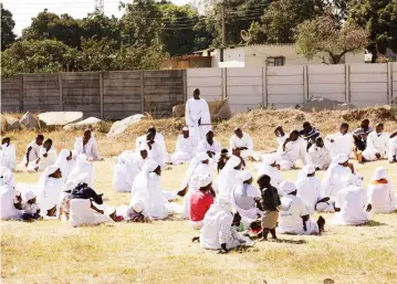  ?? — Picture: Memory Mangombe ?? Members of an Apostolic sect maintain social distancing during a service in Highfield yesterday,but without wearing face masks to curb the spread of Covid-19 as required by the law.