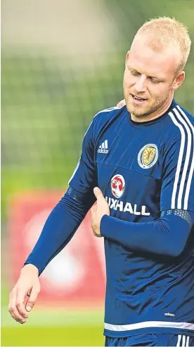  ?? Pictures: SNS Group. ?? Above: Steven Naismith gets some instructio­n from Scotland boss Gordon Strachan during a training session at Mar Hall before the squad left for Malta; right: Christophe Berra goes through some stretching exercises.