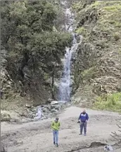  ?? RAUL ROA Los Angeles Times ?? VISITORS TAKE photos in Angeles National Forest. One official cautioned against chasing waterfalls.