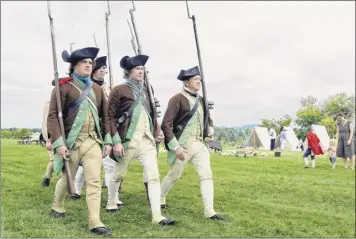  ?? John Carl d’annibale / times union ?? re-enactors drill as members of marshall’s (10th massachuse­tts) regiment at a revolution­ary War encampment on Saturday at Saratoga Battlefiel­d in Stillwater.