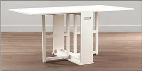  ?? Crate and Barrel ?? The Span gateleg dining table from Crate and Barrel can be tucked behind a sofa when not in use.