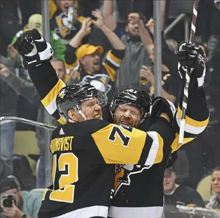  ?? Peter Diana/Post-Gazette ?? Phil Kessel, right, celebrates the first of his two goals Thursday night with Patric Hornqvist in the Penguins’ playoffcli­nching win against Detroit at PPG Paints Arena.