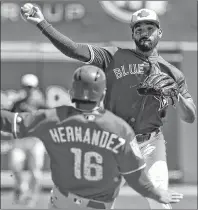  ?? CP PHOTO ?? Toronto Blue Jays second baseman Devon Travis forces out Philadelph­ia Phillies’ Cesar Hernandez at second and relays the throw to first base in time to turn a double play on Rhys Hoskins during a spring training game Wednesday in Dunedin, Fla.