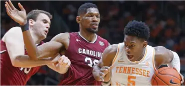  ?? (Photo by Wade Payne, AP) ?? Tennessee guard Admiral Schofield (5) drives as he's defended by South Carolina forward Chris Silva and forward Felipe Haase during Wednesday's game.