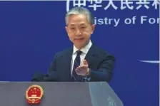  ?? AP PHOTO/LIU ZHENG ?? Chinese Foreign Ministry spokespers­on Wang Wenbin speaks Monday during a media briefing at the Ministry of Foreign Affairs office in Beijing.