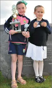  ??  ?? Sisters Louise and Clíona Kavanagh from Baile Ríach with their dancing trophies and medals after their success at the feis at Regatta Ceann Trá.