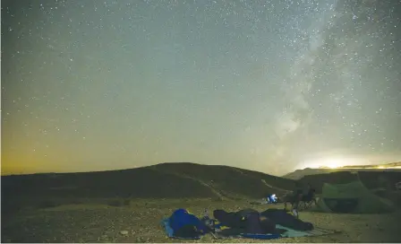  ??  ?? PEOPLE SLEEP through the annual Perseid meteor shower in the Ramon Crater last August.