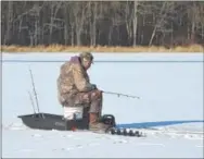  ?? PETE BANNAN – DIGITAL FIRST MEDIA ?? Bill Mendenhall of Downingtow­n ice fishes at Marsh Creek State Park Tuesday. The water depth where he was fishing he estimated was 10 feet with 5 inches of ice.