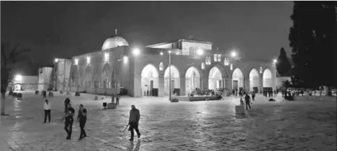  ??  ?? Visitors walk past al-Aqsa Mosque at night on the compound known to Muslims as al-Haram al-Sharif and to Jews as Temple Mount, in Jerusalem’s Old City. — Reuters photo