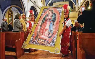  ?? Robin Jerstad / Contributo­r file photo ?? Our Lady of Angels Matachines carry a framed print of Our Lady of Guadalupe down the center aisle for the 2018 Feast of Guadalupe at the Guadalupe Church and Shrine in San Antonio.