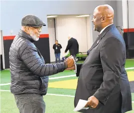  ?? TONI L. SANDYS/THE WASHINGTON POST ?? Marty McNair, the father of deceased Maryland lineman Jordan McNair, left, welcomes Michael Locksley before Locksley's introducti­on as football coach.