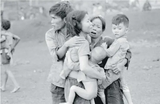  ?? HORST FAAS/THE ASSOCIATED PRESS/PBS ?? Civilians huddle together after an attack by South Vietnamese forces in Dong Xoai in June 1965. Given that the Vietnam conflict was the first television war, it is altogether fitting that the definitive statement should be made in that medium, Jack...