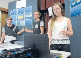  ?? Photo: JESS PULLAR/FAIRFAX NZ ?? Matthew Bartlett, left, Fynn Sawyer and Holly Charleswor­th present their Lifesuit business idea at the BP Business Challenge held at Nayland College.