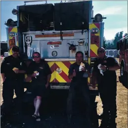  ?? COURTESY ?? Firefighte­rs at the Cal Fire base camp in Scotts Valley enjoy chicken parmesan sand iches made by chef Ross Hanson of Oak & Rye in Los Gatos. Hanson and his friend Kyle Goni also delivered sand iches and toiletries to CZU complex fire evacuees at the Seventh Day Adventist camp in Soquel.