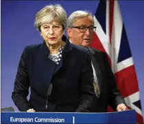  ?? VIRGINIA MAYO / ASSOCIATED PRESS ?? European Commission President Jean-Claude Juncker walks behind British Prime Minister Theresa May prior to addressing a media conference at EU headquarte­rs in Brussels on Monday.