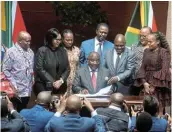  ?? Picture: FREDDY MAVUNDA/BUSINESS DAY ?? MAKING A SPLASH: President Cyril Ramaphosa ceremonial­ly signs the National Health Insurance Bill into law at the Union Buildings in Pretoria on May 15.