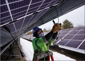  ?? (AP/Robert F. Bukaty) ?? Electricia­n Zach Newton works on wiring solar panels at the 38-acre BNRG/Dirigo solar farm, in midJanuary in Oxford, Maine.