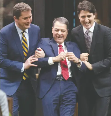  ?? Adrian Wyld / the cana dian pres files ?? Liberal MP Anthony Rota is jokingly dragged to the Speaker’s chair by Conservati­ve Leader Andrew Scheer and Prime Minister Justin Trudeau in the House of Commons in early December.