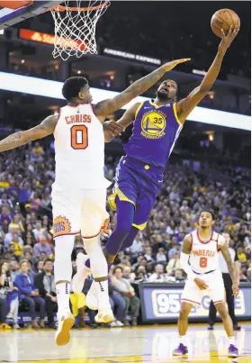  ?? Scott Strazzante / The Chronicle ?? Kevin Durant scores over the Suns’ Marquese Chriss. Durant nearly registered a triple-double with 29 points, 11 rebounds and eight assists.