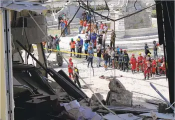  ?? RAMON ESPINOSA AP ?? Relatives watch Saturday as rescuers search for survivors of Friday’s deadly explosion that partially destroyed the five-star Hotel Saratoga in Havana, Cuba. At least 27 people were killed and 81 injured.