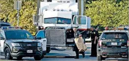  ?? ERIC GAY/AP ?? San Antonio police investigat­e the scene Sunday outside a Walmart store where eight migrants were found dead inside a truck.