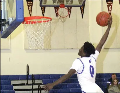  ?? PHOTOS BY BOB MINENNA ?? Semaj Clark’s one-handed slam was the signature basket in Lower Lake’s 63-49league win over the visiting St. Helean Saints on Tuesday night.