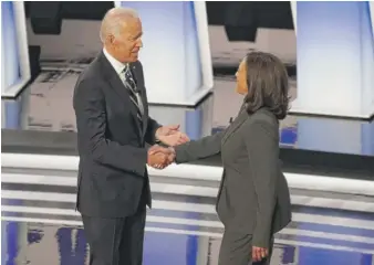  ?? PAUL SANCYA/AP ?? Former Vice President Joe Biden and California Sen. Kamala Harris shake hands July 31, 2019, before a Democratic presidenti­al primary debate in Detroit.
