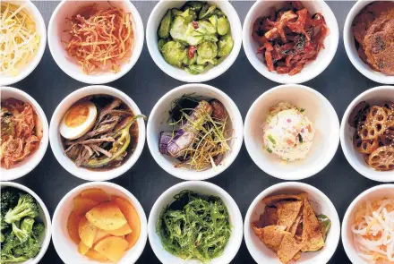  ?? CHRISTOPHE­RSIMPSON/THE NEWYORKTIM­ES ?? Fill your table with a spread of banchan, the small dishes that often accompany a Korean meal.