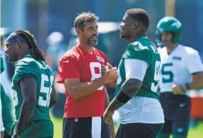  ?? SETH WENIG AP ?? Jets QB Aaron Rodgers (left), greeting Quinnen Williams at the team’s training facility in Florham Park, N.J., agreed to a new two-year, $75 million guaranteed contract.