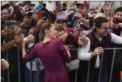  ?? AUREA DEL ROSARIO — THE ASSOCIATED PRESS, FILE ?? Ruling party presidenti­al candidate Claudia Sheinbaum greets supporters upon her arrival to her opening campaign rally in Mexico City.