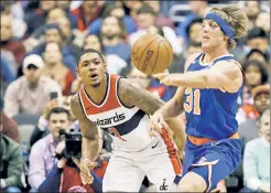  ?? AP ?? PAYING THE PRICE: Ron Baker, makes a pass around Washington’s Bradley Beal on Wednesday, is wearing a protective mask after suffering an orbital bone fracture while trying to defend a dunk against New Orleans’ Anthony Davis on Saturday.