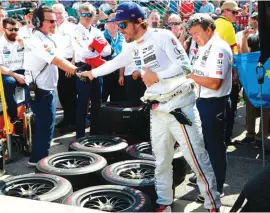  ??  ?? Fernando Alonso, of Spain, shakes hands with a crew member during yesterday’s final practice session Photo: AP